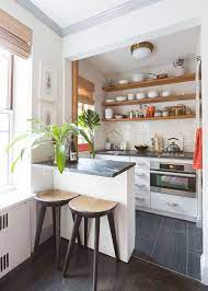 The small range hood, storage cabinets, and shelves for hanging pots and. Design And Layout Of A Square Kitchen Decor Around The World Kitchen Design Small Small Apartment Kitchen Small Kitchen Tables