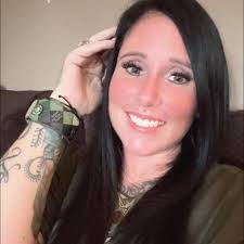 The eye of a wild alligator, underwater at night in the everglades. If you  look at the eye you can also see a blueish tint to it, this is the  nictitating membrane,