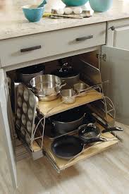 This cabinet uses a wire divider to keep cutting boards and pans upright, but that overhead space can do more. Base Pots And Pans Pull Out Schrock Cabinetry