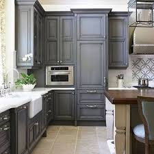 A minimalist light blue kitchen with grey additional cabinets and a concrete countertop plus a white tile backsplash a navy kitchen with butcherblock countertops, a grey tile floor and a grey beaded chandelier for a bold touch Kitchen Design With Light Grey Cabinets