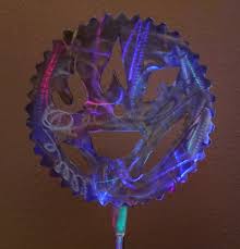 Maybe you would like to learn more about one of these? Lighted Saw Blade Sculpture Showing Different Colored Reflections