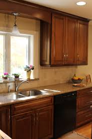 Medium Dark Raised Panel Cabinetry With Crown Molding Granite Countertops And Windowsill Black Dishwasher Tiled Backsp Kitchen Redo Kitchen Upstairs Kitchen