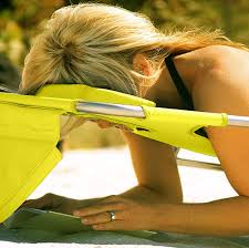 Open / close face cavity with arm slots, pillow and adjustable chair back allows for comfortable tanning or reading while on your back or stomach. Pure Genius This Beach Chair Has A Face Hole For Reading And Napping