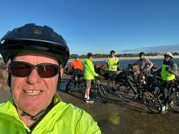 Holt ride 2020. Steve in orange/red jersey, waving in some photos. Steve,  solo, having climbed Holt hill.