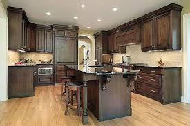 Dark stain on the cabinets provides a warmer, more inviting feel for the kitchen. Dark Stained Wood Corbels Dark Wood Kitchen Cabinets Cabinet Cures Of Raleigh Durham