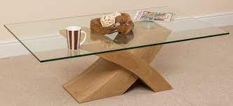 Glass coffee tables are modern and elegant, while also creating the illusion of space because of its clarity and transparent nature. Milano Stylish Glass And Wood Coffee Table Modern X Shaped Cross Base Low Living Room