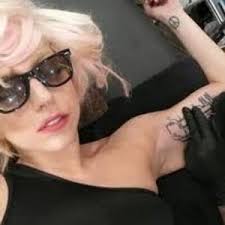 Lady gaga has a large tattoo of roses that spans from her lower back to the left side of waist. Lady Gaga Tattoos Best Tattoo Celebrities Tattoos