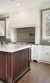 Cream Kitchen With Large Decorative Range Hood And Cherry Island Design Ideas Classic White Kitchen Classic Cabinets Kitchen Design