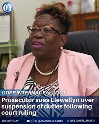 Director of Public Prosecutions Paula Llewellyn is facing legal action from  one of her own senior prosecutors following her decision to remove the  government attorney from active legal duties for six months.