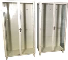 This is basically the medicine cabinet's version of a kangaroo pouch: Pair Of Vintage Medicine Cabinet Display Cabinet Metal Industrial Comes With 4 Glass Shelves Design Market