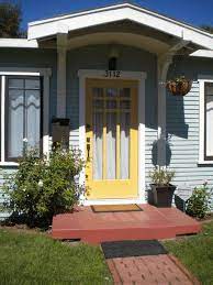 This mellow yellow or soft yellow door welcomes visitors in a cheery fashion. Andi S South Park Bungalow House Front Door Best Front Doors Yellow Doors