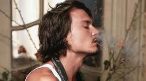 Johnny's long hair is in a ponytail and slightly unkept. Johnny Depp He Knows How To Dress