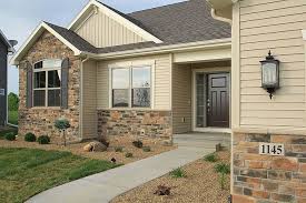Warm Tan Yellow Siding With Beautiful Stone And Shutters Stone Exterior Houses Ranch House Exterior Yellow House Exterior