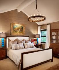 The natural fibers are glazed with a metallic bronze. Austin Dark Brown Bedding Contemporary Bedroom Beige Ceiling Beams Curtain Upholstered Bright Blue Table Lamp Grasscloth Wallpaper