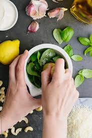 Making Pesto In A Motar With A Pestle Stocksy United Green Pesto Food Hand Healthy Woman Basil Cashew Cheese From Above G Green Pesto How To Make Pesto Food