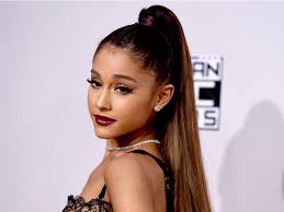 A ponytail is a hairstyle in which some, most or all of the hair on the head is pulled away from the face, gathered and secured at the back of the head with a hair tie, clip. Ariana Grande Switched To A Low Ponytail
