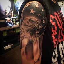 A shoulder tattoo of the american flag with a cemetery as the foreground. Patriotic American Flag Eagle Tattoo Black And White Novocom Top