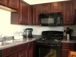 A Comfy Little Place Of My Own Chalkboard Backsplash Kitchen Cabinets With Black Appliances Dark Brown Kitchen Cabinets Maple Kitchen Cabinets