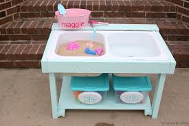 discarded sink turned sand & water table