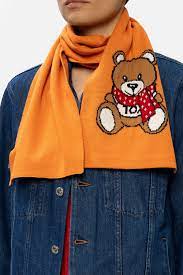 On the table there's a green lamp. Teddy Bear Scarf Moschino Vitkac Singapore