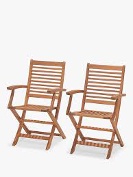 A wooden table and wobbly chairs make up the furnishings. Anyday John Lewis Partners Venice Folding Garden Armchairs Fsc Certified Eucalyptus Wood Set Of 2