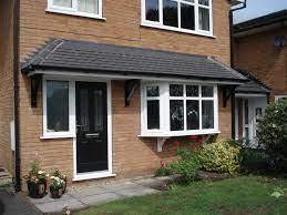 In achieving fire rated certification, we provided wood doors to high end hotels and apartments. A Tiled Front Door And Window Canopy Supported By Two Pieces Of Solid Timber Giving A House The Wow Factor To G House Canopy Front Door Canopy Porch Canopy