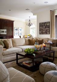 Large Beige Sectional With Brown And Green Accent Pillows Creamy Neutral Walls With Tonal Silk Dra Beige Living Rooms Brown Couch Living Room Brown Sofa Decor