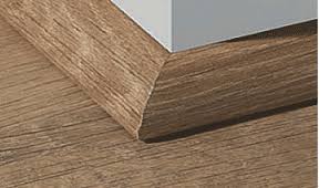 He ran the floor up to the existing baseboards and then installed 1/4 round molding to cover the gaps. Site Glossary