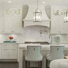Pure white and designed to reach the ceiling, clean and simple inset cabinets, white cabinets, white backsplash, stainless steel appliances, an island and gray countertops i like the grey tile and the backsplash with the grey. Off White Eclipse Kitchen Cabinets Design Ideas