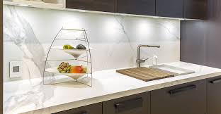 Neolith calacatta splashback and benchtop, combined with blue and timber cabinetry. Neolith Classtone