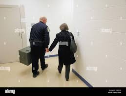 Blount County Sheriff Lt. Lee Slagle, left, escorts Joyce Tapscott (right)  out of Justice Center in Maryville, Tennessee to her car Thursday, Jan. 23,  2014, with her father Dr. George Andrew Zirkle