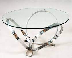 Innovatively designed rounded coffee table featuring a sturdy metal frame and a glass top. Modern Round Glass Coffee Table Round Glass Coffee Table Glass Coffee Table Metal Base Coffee Table