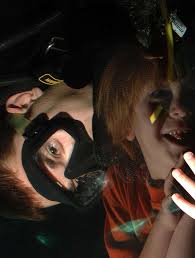 Navy Diver 1st Class Brian Levins greets a visitor in the aquarium at Henry  Doorly Zoo in Omaha.