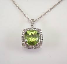 Often associated with peace, good fortune and happiness, this gemstone primarily come from egypt and was often worn by the ancient pharaohs. White Gold Peridot And Diamond Halo Pendant Necklace 18 Chain August Birthstone