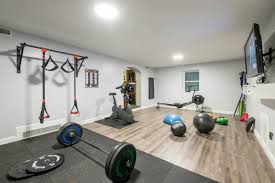Gray basement game room features a vintage pool table placed beneath a chandelier hung from a stained wood plank ceiling and. Water Damaged Basement Transformed Into A Functional Home Gym Karlovec Co