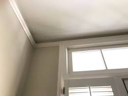 Corner blocks of colonial revival crown molding draw the eye upward to the vaulted, beadboard ceiling. Crown Molding In Old Colonial House