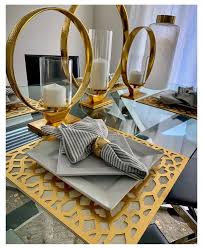 A subtly textured ceiling and the rough wood finish of the table add texture to the room and contrast the bold, cheerful colors of the chairs and décor. Glam Gold Decor Gold Dining Table Decor Golddiningtabledecor I Love My Dining Room In 2021 Dining Room Table Decor Gold Dining Room Table White Dining Room Decor