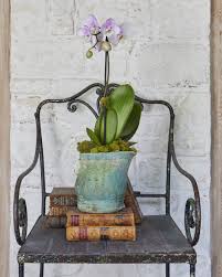 It's all in the details. This antique chair looks perfect in a light filled  foyer. We decided stacking it with books and flowers would make an  interesting and creative arrangement. #interiorstyling #interiordesignideas  #