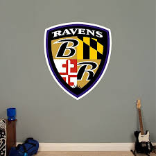 The yellow shield with a bold stylized letter b in purple with a white outline, had a double black and purple frame and two sharp and elegant wings. Baltimore Ravens Shield Logo Officially Licensed Nfl Removable Wall Decal Sports Wall Decals Sheild Logo Raven