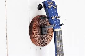 Frames are of black square metal tubes. Ukulele Wall Hanger Hang Ukes With Handmade Wooden Wall Etsy Wall Hanger Ukulele Wall Ukulele Wall Mount