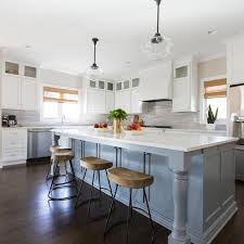 The walls, island, cabinets, and chairs are white, so having darker floors is a nice contrast. Photos Hgtv