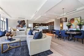 This Unit Features An Open Floorplan Utilizing Deep Hues Of Denim Colored Dining Chairs And Accents Throu Colored Dining Chairs Decor Home