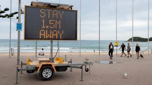 A man crosses an empty highway on february 3. Coronavirus Australia Case Increase Slows As Lockdown Takes Effect