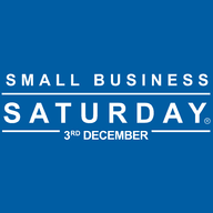 Small business owner at entrance looking at camera portrait of happy woman standing at doorway of her store holding digital tablet. Small Business Saturday Uk Another Year Making A Big Difference