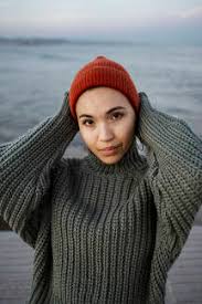 See more ideas about knitted hats, hat pattern, knitting. Woman Wearing Knit Hat Standing With Hands Behind Head Against Sea Stockphoto