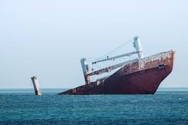 ship sinking on ocean at daytime photo