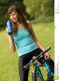 Thirsty woman on bike stock image. Image of refreshment - 10169817
