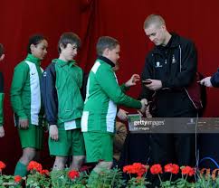 Bradford City's Louis Horne hands medals to players from Bradford... News  Photo