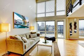 White loft interior with white brick wall, lamp and flowers with wooden blue ceiling with lamps. Modern Loft Apartment Living Room Interior With High Ceiling Stock Photo Picture And Royalty Free Image Image 17771867