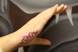 Pink Bow On Side Of Hand Tattoo Considering Hand Tattoos Hand Tattoos For Women Side Hand Tattoos